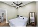 Cozy bedroom features wood floors, ceiling fan, ensuite bathroom and large mirror at 18520 Ambly Ln, Tampa, FL 33647