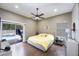 Bright bedroom with pool access, ceiling fan, wood floors creating a relaxing retreat with outdoor connection at 18520 Ambly Ln, Tampa, FL 33647