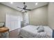 The light bedroom is complete with wood-look floors, ceiling fan, and a mirrored closet at 18520 Ambly Ln, Tampa, FL 33647