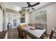 Bright dining room with a ceiling fan, wood floors, and access to a study through french doors at 18520 Ambly Ln, Tampa, FL 33647