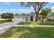 Charming single-story home with well-manicured lawn and mature tree providing shade at 18520 Ambly Ln, Tampa, FL 33647