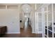 Hallway with an arched ceiling and view to a study through french doors at 18520 Ambly Ln, Tampa, FL 33647
