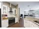 Modern kitchen features stainless appliances, granite counters, open layout flowing to living space, ideal for gatherings at 18520 Ambly Ln, Tampa, FL 33647