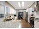 Modern kitchen with stainless steel appliances, granite countertops, and ample natural light provides style and function at 18520 Ambly Ln, Tampa, FL 33647