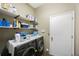 Well-organized laundry room with washer, dryer, shelving, and cleaning supplies for efficient home management at 18520 Ambly Ln, Tampa, FL 33647