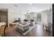 Open living room featuring a fireplace, neutral walls, wood floors, and a ceiling fan at 18520 Ambly Ln, Tampa, FL 33647