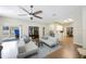 Bright living room with backyard access, hardwood floors, and open flow to the kitchen offers comfort and style at 18520 Ambly Ln, Tampa, FL 33647