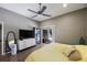 Bright main bedroom with a ceiling fan and sliding doors to the outdoor swimming pool at 18520 Ambly Ln, Tampa, FL 33647