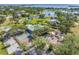 Overhead view featuring tennis courts, a community pool, and recreation area, set amidst a scenic landscape with water views at 2101 N Pointe Alexis Dr, Tarpon Springs, FL 34689