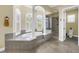 Luxurious bathroom with a soaking tub, walk-in shower, and elegant tile work with a separate toilet at 2101 N Pointe Alexis Dr, Tarpon Springs, FL 34689