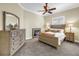 Inviting bedroom with a cozy bed, ceiling fan, and ample natural light from the window at 2101 N Pointe Alexis Dr, Tarpon Springs, FL 34689