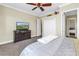 Comfortable bedroom featuring a ceiling fan, neutral color palette, and a television at 2101 N Pointe Alexis Dr, Tarpon Springs, FL 34689