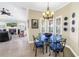 Bright dining room features a glass table, chandelier, and views to living room at 2101 N Pointe Alexis Dr, Tarpon Springs, FL 34689
