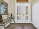 Elegant entryway with double doors, shutter blinds, and decorative console table at 2101 N Pointe Alexis Dr, Tarpon Springs, FL 34689