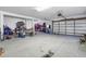 Oversized three car garage with white walls, and ample storage space at 2101 N Pointe Alexis Dr, Tarpon Springs, FL 34689