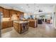 Open-concept kitchen with a large island, custom cabinetry, and views of the living area at 2101 N Pointe Alexis Dr, Tarpon Springs, FL 34689