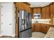 Gourmet kitchen featuring stainless steel appliances, custom cabinets, and granite countertops at 2101 N Pointe Alexis Dr, Tarpon Springs, FL 34689