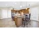 Gourmet kitchen featuring custom cabinets, an island with bar seating, and stainless steel appliances at 2101 N Pointe Alexis Dr, Tarpon Springs, FL 34689