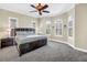 Comfortable main bedroom with large windows, arched windows, and a ceiling fan for optimal relaxation at 2101 N Pointe Alexis Dr, Tarpon Springs, FL 34689
