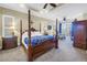 Spacious main bedroom with four-poster bed, sitting area, and access to a private balcony with lots of natural light at 2101 N Pointe Alexis Dr, Tarpon Springs, FL 34689