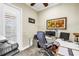 Bright home office featuring a large desk, comfortable chair, and natural light from the window at 2101 N Pointe Alexis Dr, Tarpon Springs, FL 34689