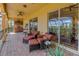 Expansive outdoor patio with comfortable seating, a built-in grill, and stunning views of the surrounding landscape at 2101 N Pointe Alexis Dr, Tarpon Springs, FL 34689