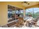 Inviting outdoor patio with a dining table, comfortable seating, and scenic views of the surrounding landscape at 2101 N Pointe Alexis Dr, Tarpon Springs, FL 34689