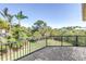 Private outdoor patio provides a tranquil view of lush landscaping and clear blue sky at 2101 N Pointe Alexis Dr, Tarpon Springs, FL 34689