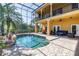 Outdoor pool area with a beautiful screened enclosure and ample seating on the patio at 2101 N Pointe Alexis Dr, Tarpon Springs, FL 34689