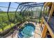 Inviting screened-in pool area with lush landscaping and an inflatable float, perfect for relaxation and fun at 2101 N Pointe Alexis Dr, Tarpon Springs, FL 34689