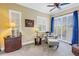 Cozy sitting area with comfortable armchair and ottoman next to window with plantation shutters and blue curtains at 2101 N Pointe Alexis Dr, Tarpon Springs, FL 34689