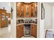 Charming wet bar features glass cabinets, a wine fridge, and ample counter space for entertaining at 2101 N Pointe Alexis Dr, Tarpon Springs, FL 34689