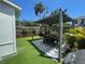 Green turf and privacy fencing surround a shaded patio at 212 41St S St, St Petersburg, FL 33711