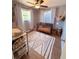 Charming Bedroom with hardwood floors, a crib, and natural lighting at 212 41St S St, St Petersburg, FL 33711