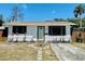 Charming home with a light green door, stone pathway, and landscaped yard at 212 41St S St, St Petersburg, FL 33711
