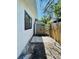 Exterior shot of storage shed with double doors and surrounding pavers and wood fence in the backyard at 212 41St S St, St Petersburg, FL 33711