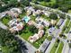 Attractive aerial view of the condo buildings, pool, landscaping, and parking lot in this beautiful residential community at 2211 Belleair Rd # D3, Clearwater, FL 33764