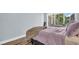 Bright bedroom features a window with a view and modern wood-look flooring at 2211 Belleair Rd # D3, Clearwater, FL 33764