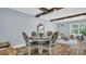 Dining area with wood-look floors, table with seating, and an open view to the living room and natural light at 2211 Belleair Rd # D3, Clearwater, FL 33764
