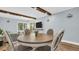 Dining area with wood beam details, adjacent to living area, with table and chairs at 2211 Belleair Rd # D3, Clearwater, FL 33764