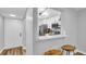 View of the kitchen from the adjacent living space, showing the white cabinets, stainless appliances, and pass-through at 2211 Belleair Rd # D3, Clearwater, FL 33764