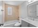 Bathroom with shower over tub, modern vanity, and neutral tile at 2214 Selkirk St, Valrico, FL 33594