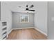 Well-lit bedroom with neutral walls, modern ceiling fan, and wood-look laminate flooring at 2214 Selkirk St, Valrico, FL 33594