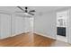 This bedroom offers a ceiling fan, wood-look floors, and an ensuite bath and closet at 2214 Selkirk St, Valrico, FL 33594