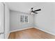 This bedroom features wood-look flooring, natural light, and a ceiling fan at 2214 Selkirk St, Valrico, FL 33594