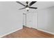 This bedroom features wood-look flooring, neutral paint, and access to closets and baths at 2214 Selkirk St, Valrico, FL 33594