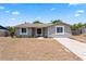 Charming single-story home featuring a well-maintained lawn and freshly painted exterior at 2214 Selkirk St, Valrico, FL 33594