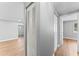 Bright hallway leading to living area, with wood-look flooring and closets at 2214 Selkirk St, Valrico, FL 33594
