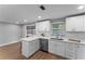 Updated kitchen with stainless steel appliances, granite countertops, and white cabinetry at 2214 Selkirk St, Valrico, FL 33594