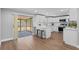 Modern white kitchen with stainless steel appliances, breakfast bar, and sliding glass door to screened patio at 2214 Selkirk St, Valrico, FL 33594